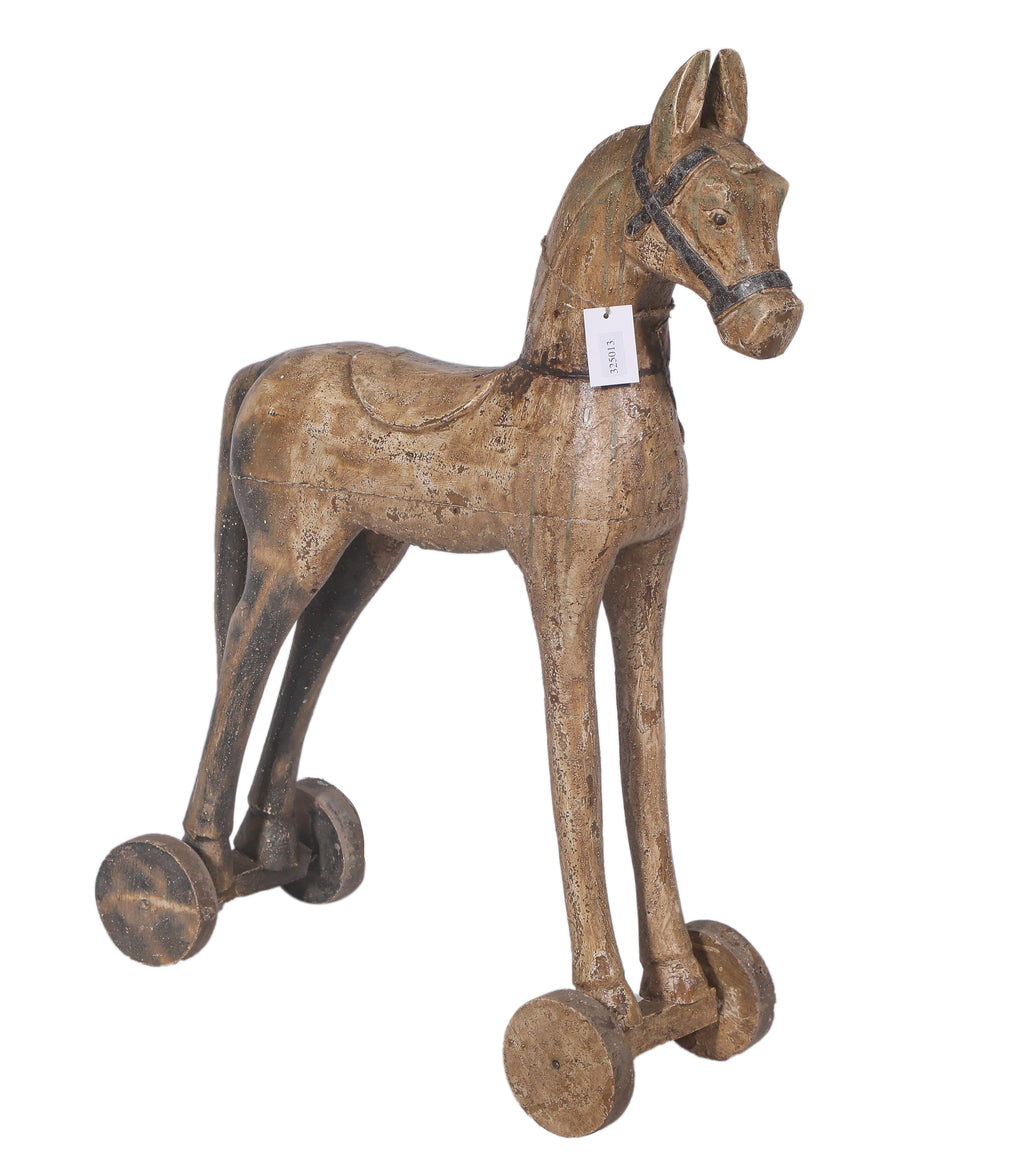Cheval ancien sur roulettes en bois sculpté